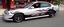 Placeholder: suped up 2004 chevy impala supersport musclecar, silver with black flames outlined with a thin red pinstripe, in front of Sam's club, SuperSport car, impressive, VIP, award winning, detailed