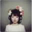 Placeholder: Polaroid head shot of young Bjork, big pouty lips, red nose, hair adorned with flowers, rosy cheeks and rosy nose, headphone