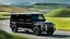 Placeholder: A sleek ((( bulk g wagon))) with a majesticly curved rear, cutting through a (sunny, open countryside) backdrop
