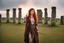 Placeholder: Full body shot of a tall slim red-headed young woman, dressed like a gipsy, standing in front of Stonehenge in a flaming circle