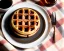 Placeholder: Round waffle with maple syrup plate, plaid napkin fork