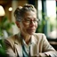 Placeholder: medium-full shot of a Monday lover with deep wrinkles and a warm smile and eyeglasses, sitting in a charming cafe with plants in the background, looking at the window, wearing a pastel linen blazer with a floral print, natural afternoon light shining through the windows, shot on Agfa Vista 200, side-angle view, 4k, --stylize 1000