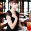 Placeholder: Russian guy boyish boylike short man's haircut boyish features in black girlish lacy cocktail dress in restaurant