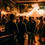 Placeholder: a crowded smokey bar, lots of people, focus on a lonely person against the wall