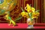 Placeholder: 1512857901 hypersigil photograph of a beautiful yellow and red orchid in a clear glass rococo inspired vase on a mirrored deco themed end table in a shadowy corner of a nouveau era room with wood paneling in the style of Robert maplethorpe, tropical birds, lizards, snakes, insects, gorgeous, shamanic, ethereal, photorealistic, embellishments, long shot, wide shot, dof, deep focus, 3d render