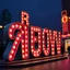 Placeholder: advertisings on giant signs in an unknown alphabet, street, made of cake-frosting and felt, volumetric light, jahykpli, hypermaximalist, sknub, nightmare, sparkles, bokeh, 3d, logo, hasselblad h6d400c --ar 85:128 --v 6.