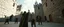 Placeholder: mintegrated_multimodal_description: [Shot 6] An eight-second cinematic fantasy scene in an ancient stone courtyard of a Forgotten Realms castle, late afternoon. Begin with a low wide establishing shot moving slowly forward toward a young wizard in a weathered green cloak and his adventuring companions, a rugged barbarian and cautious ranger. Two goblins approach in the background. The camera gently arcs around the wizard as he raises his staff and confidently begins a summoning spell. poster