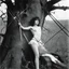 Placeholder: [high res photo by Kishin Shinoyama (1968)] a female Barbarella version of Saint Sebastian wounded by arrows along the trunk of a tree
