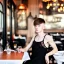 Placeholder: Russian guy boyish boylike short man's haircut boyish features in black girlish lacy cocktail dress in restaurant