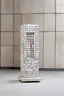 Placeholder: Minimalistic solid porcelain sculpture of vacant and empty street commercial walk-in kiosk on legs, circa 2000, covered with mosaic, in a contemporary urban art gallery context, 7 centimeters height, semi-height wide shop windows and door, small square window for cash in facade, flat roof, one-story, one-room. Inspired by Bruno Munari, Benetton, gestalt theory, geometry of Castel del Monte, metamodernism and purism.