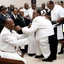 Placeholder: A ku klux Klansman being spanked by Louis farrakhan