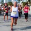 Placeholder:  old Sonia Lombardi running a marathon on Miami beach, full body, about to cross the finish line, photo realistic, 8k, realism