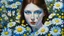 Placeholder: Oil painting of a woman with light skin and dark hair, surrounded by a dense vegetation of white and yellow daisies and small blue flowers, creating a floral setting around her face. Two white butterflies with blue spots are located among the flowers, one near her left temple and another on the right side of the composition. The woman has dark blue eyes, freckles, and blue lips. Her face features small, whimsical details, such as a small caterpillar near her left eye, a heart drawn on her cheek,