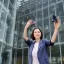 Placeholder: A short haired, light breasted female computer engineer taking a selfie in front of Building 92 at Microsoft