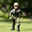 Placeholder: G.i. Joe Biden toy doll airforce camo flightsuit face (plastic hair) sunglasses with black boots full body in package handgun 2028