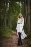 Placeholder: full body standing beautiful 20 year old girl with ash blonde hair and blue eyes with her long hair down, wearing a white sleeved shirt and nice sarifon dress, and lilac long leggings, with long black boots full body shot walking along trees