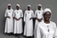 Placeholder: 4 suore africane con tunica grigia figura intera sorrisi