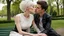 Placeholder: close up photo from the back from a (25 year old human android woman, short white hair, white albino skin) kissing with ((dark hair young man)), sitting on the bench, detalied, sharp focus, realistic, full body, bench, in the blur background a green park