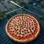 Placeholder: Photograph from a helicopter looking down on a parking lot where a colossal pepperoni pizza takes up the entire lot, fantastical, gigantic food, concept art, realistic looking