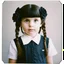 Placeholder: wednesday addams as a child, braids, frange, with black roses, worn polaroid, 1970s, thretaning