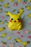 Placeholder: cute and nice faced marzipan Pikachu on a lace blanket on a kitchen table