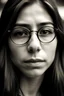 Placeholder: 27 year old Hispanic women almond shaped eyes, long brown hair, straight nose, thin lips. Face etched with worry, wearing small John Lennon style glasses. Wise beyond her years