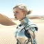 Placeholder: A photo of a futuristic girl from Dune's film made of metal in the style of Hajime Sorayama, inside a light white digital desert landscape.