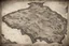 Placeholder: a scan of an ancient North American Cree printed road map of a fictional place that was black and white but has since been stained and weathered