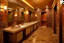 Placeholder: Pictures of a group of bathrooms in Mathaf Restaurant. The walls and floors are colored in brown tones