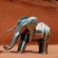 Placeholder: A mechanical chrome elephant looking at a Robotic Bedouin in Sahara by arik roper