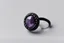 Placeholder: небольшое чёрное кольцо с лиловым камнем