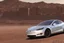 Placeholder: A Tesla 'Model S' is drifting at high speeds, in Mos Eisley on the planet Tatooine. (CINEMATIC, WIDE ANGLE LENS, PHOTO REAL)