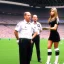 Placeholder: Jennifer Aniston in a referee jersey officiating for a soccer match at Wembley Stadium