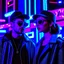 Placeholder: street photography of a man and woman, night time, cyberpunk neon lights, 16mm , perfect photography, 1980's,vhs footage,wearing futuristic VR,low light,shot by jvc gr-sz7,glitch,back to the future