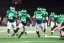 Placeholder: Boston Shamrocks Football team playing against the Toronto Rifles Football team,vintage, hyper-realistic, in color, Boston in green, Toronto in Red