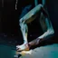 Placeholder: Minimal abstract oil paintings close up person limbs sinew and concrete fragments illuminated at night style of Justin Mortimer