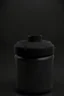 Placeholder: Black protein powder container, lid besided the container, screw lid, round container, black studio, black background, dark setting, no labels on the container, very detailed, realism, high quality