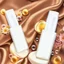 Placeholder: two cosmetics bottles are on a silk fabric, behind a beautiful floral spring floral background, the picture is top view, in the background there are beautiful soap bubbles, molecules and honeycombs, high-quality picture, top view