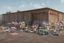 Placeholder: can you please generate an image of supermarket design in a refugee camp that sells imported goods like clothes, bottled water, cleaning products ect
