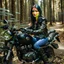 Placeholder: Very attractive woman sitting on a motorcycle. The bike is Yamaha. In the background is a forest.