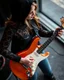 Placeholder: beautiful woman(wearing a dark lace hoodie) playing an electric guitar at high angle