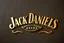 Placeholder: a Jack Daniels style graphic element made of brass