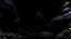 Placeholder: dark rock cave, looking upward as the cave continues upward. A stream runs down the the left side, lined by a small dam, in the style of jordan grimmer