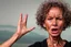 Placeholder: Generate an 8K UHD image of a 65-year-old skinny, curly-haired lady, her right hand holding a large, shiny piece of coal. Her face, a masterpiece of contradictions—wrinkled forehead and squinted eyes betray trapped desperation, while her wide-open mouth emits a scream of rage so intense that saliva flies. Capture the collision of emotions, depicting the woman on the brink of joy and desperation as she confronts the culmination of her emotional journey