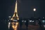 Placeholder: around Eiffel tower a few people with umbrella walking while it is raining at night and the Eiffel is seen complete