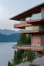 Placeholder: Maison design bois béton avec vue sur lac dans montagnes. Lumière soleil couchant