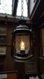 Placeholder: milting candle inside an old lamp hanging in an old museum