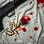 Placeholder: luger lying on a white silk sheet with bullets and a rose in a pool of blood