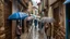 Placeholder: Narrow street of a traditional village on a rainy day, where the many passers protect themselves from the rain with umbrellas