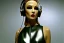 Placeholder: Photographic. Technological utopia. Machine, creamy fake skin, old-camera-eyes. 3D-tiling on the adaptive background. Lightly armored. Bio-punk full-mask. Lay figure woman is Surreal. Haute Couture 1990's. Light from right. Colors are silver, olive, terracotta and black. Old AKG headphones, golden rings & disc. Logo. Thick tights. Thick calves. Curved fell. Wide hip. Tron Movie. Countermove. No hairs! The Matrix clothes made of lamb wool. Daft Punk. Biological recycling method.